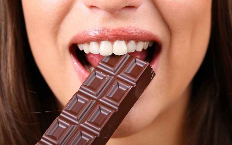 Closeup of woman eating chocolate