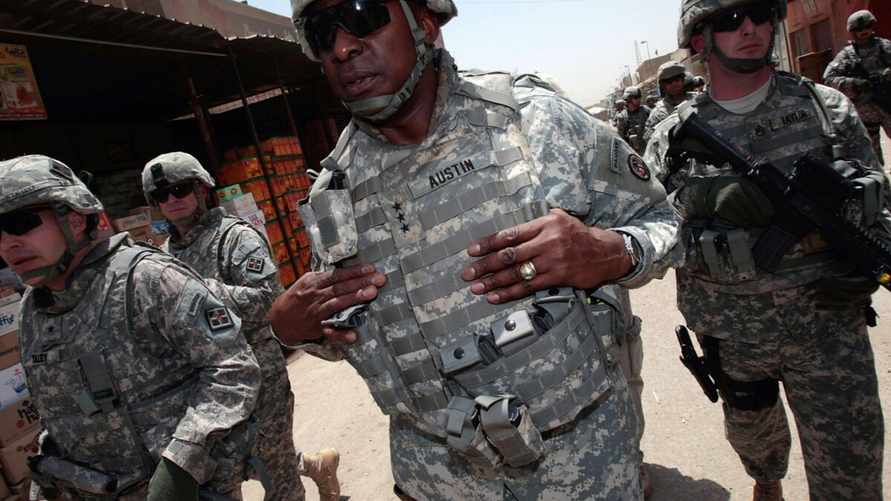 BAGHDAD, IRAQ - MAY 28: Brig. Gen. Jeffrey Talley (L) and US Army Lt. Gen. Lloyd J. Austin III (C) along with members of their entourage tour the Jamila market of Sadr City May 28, 2008 in Baghdad, Iraq. A number of high-level officers toured the market, one of Baghdad's largest and most important, in an assessment trip in the aftermath of two months of fighting that left the market nearly abandoned. Returning business to the the market is a priority for US troops, who see prosperity as a way to prevent local Iraqis from joining resistance movements. (Photo by Chris Hondros/Getty Images)